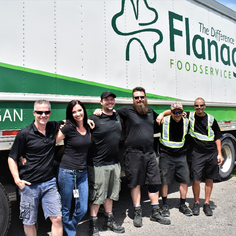 Flanagan drivers standing beside truck